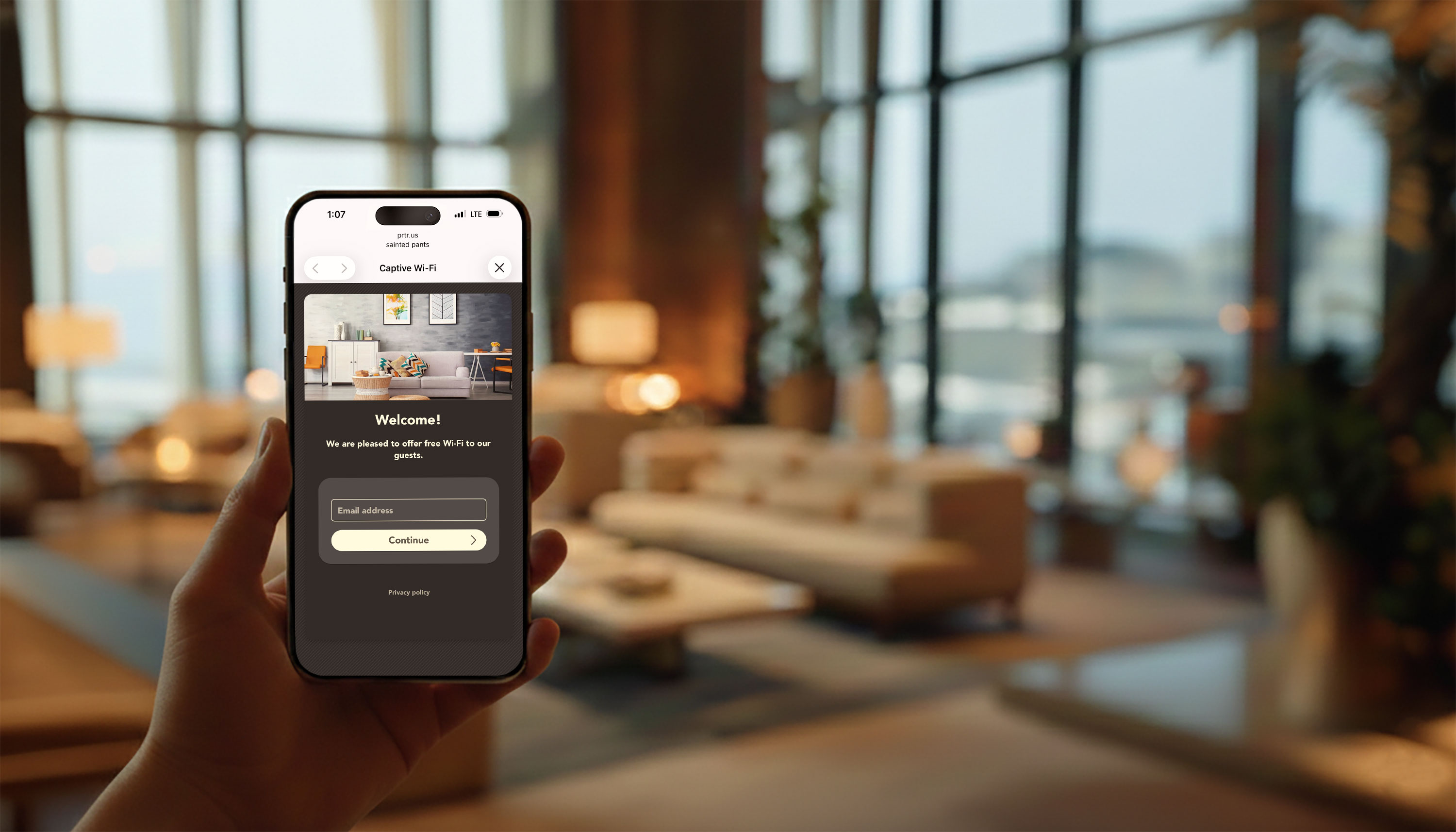 Happy guest holding an iPhone showing a branded Wi-Fi splash page