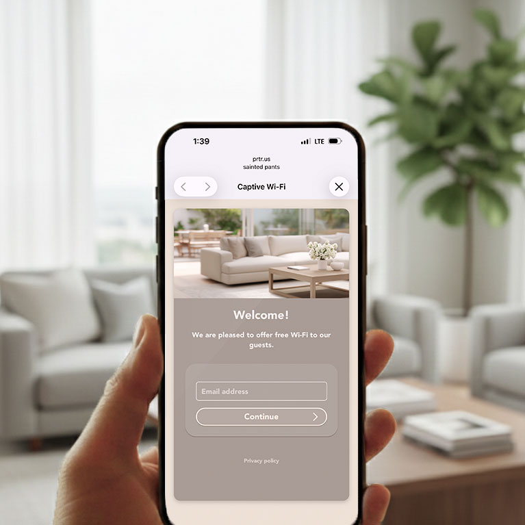 Happy guest holding an iPhone showing a branded Wi-Fi splash page
